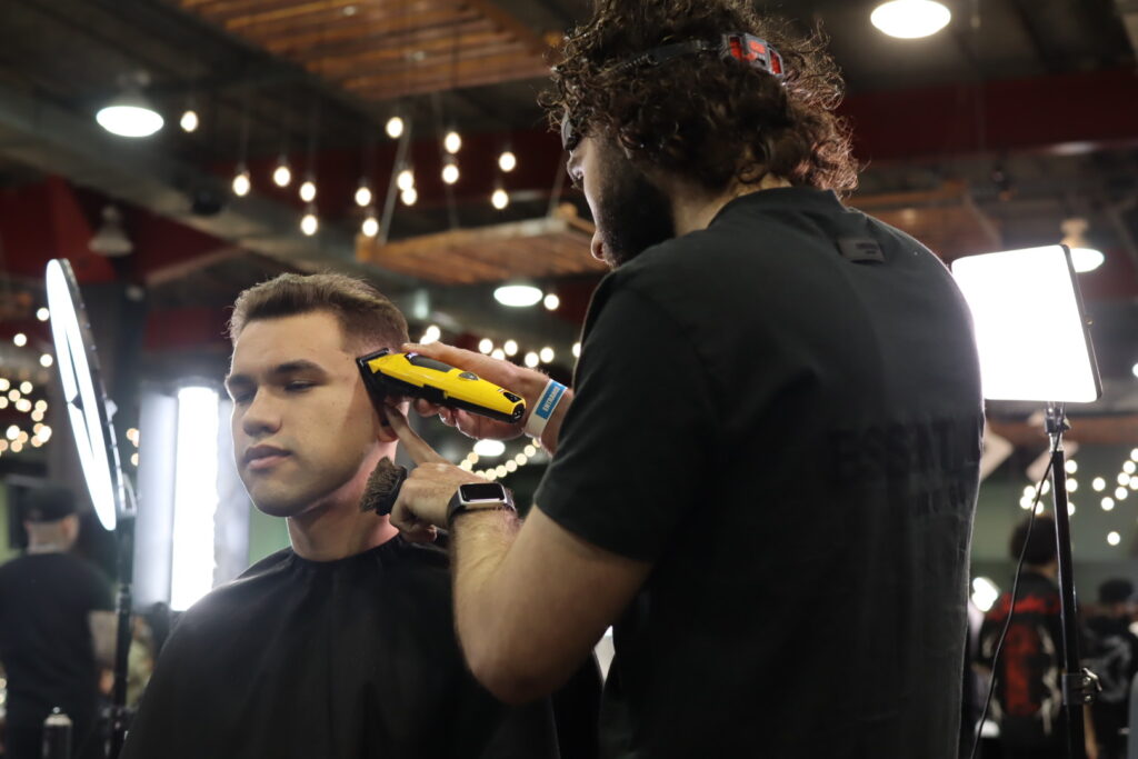 Barber is cleaning up a haircut